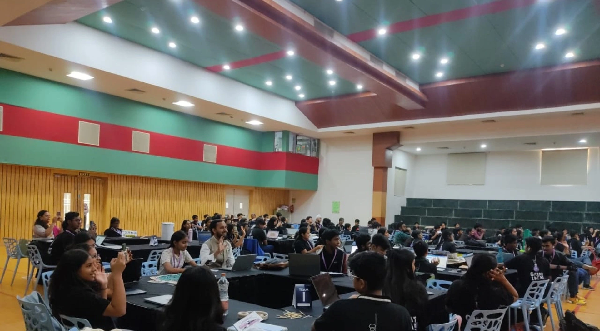 Students in a large Cloud Robotics workshop hall